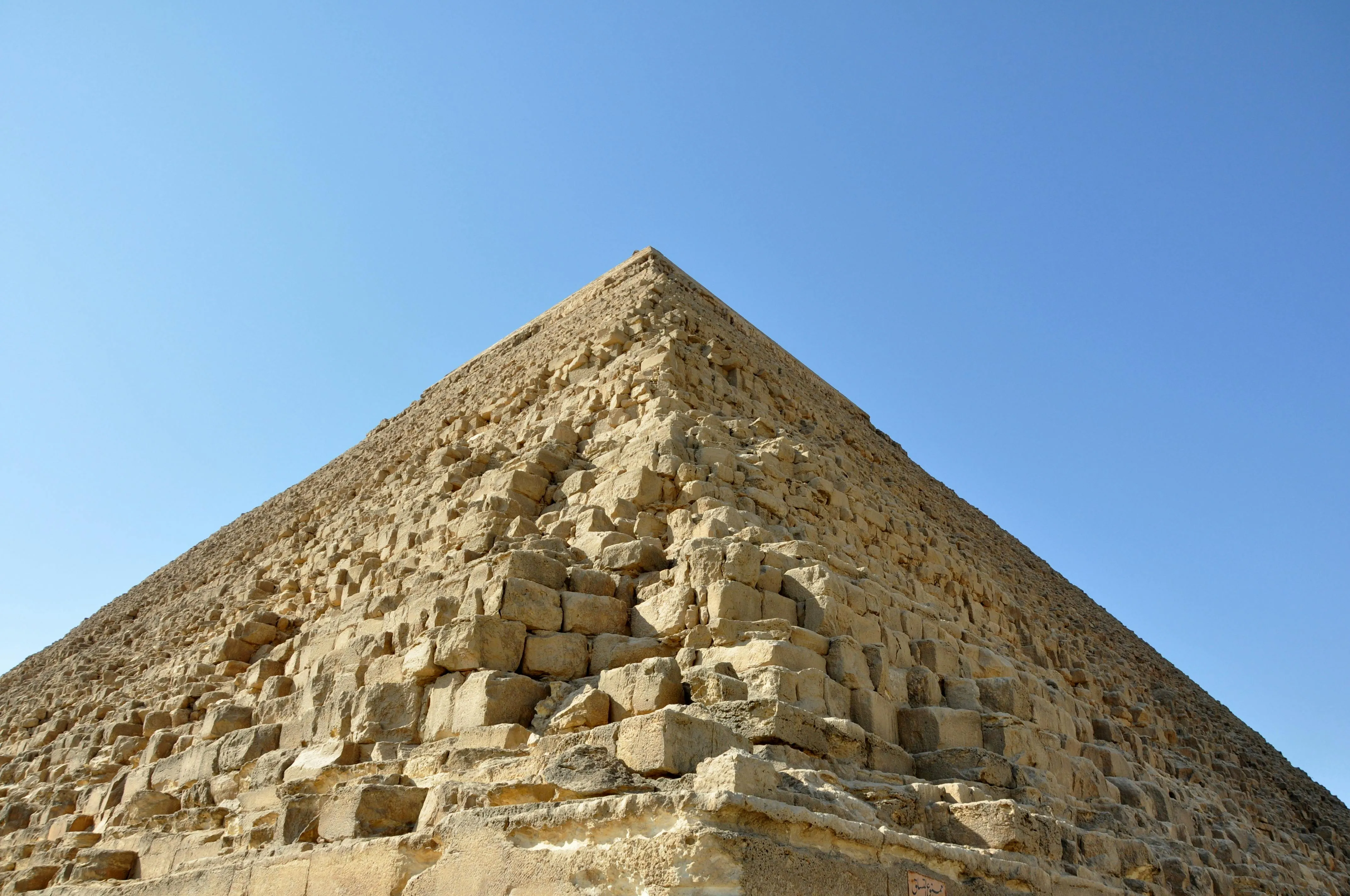 Ancient pyramids with a crumbling base, impressive on the outside and eroding from below