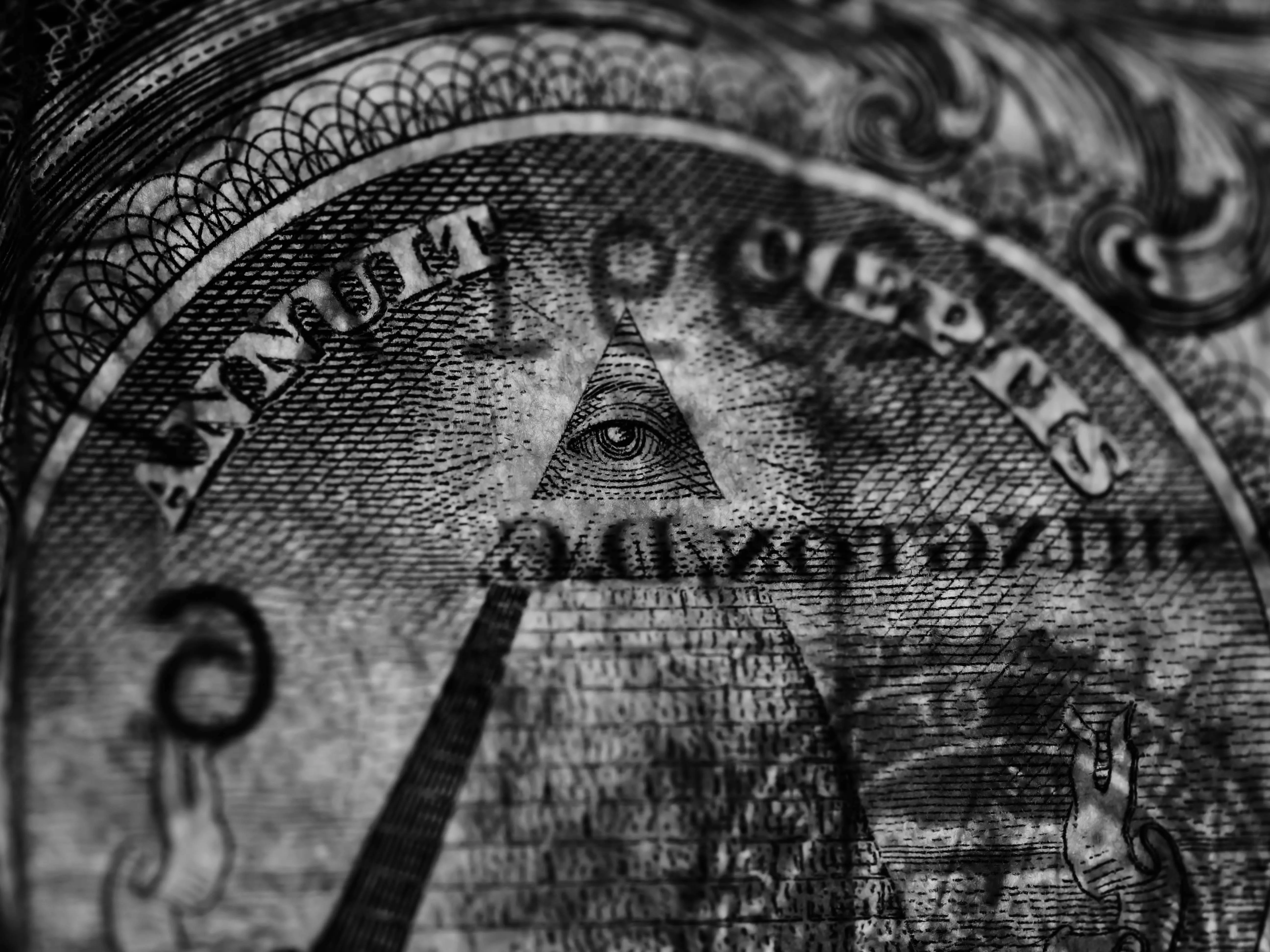 A close-up of the all-seeing eye on a dollar bill, scrutinizing your actual capital needs